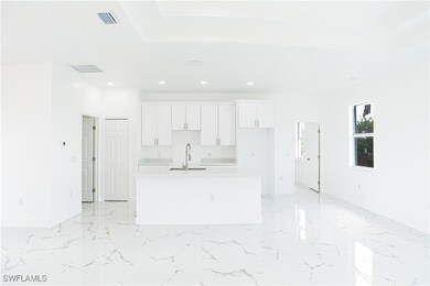 Kitchen featuring white cabinets, sink, and a kitc