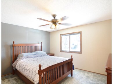 Upper level bedroom with front facing window.