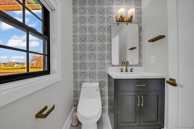 Half bathroom with healthy amount of natural light and vanity