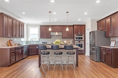 Kitchen featuring pendant lighting, crown molding,
