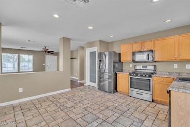 Kitchen featuring stainless steel appliances, recessed lighting, ceiling fan, and light brown cabinets
