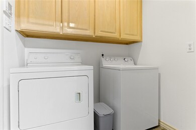 Laundry room off kitchen and garage