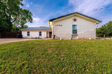 Single story home with brick siding, fence, and a 