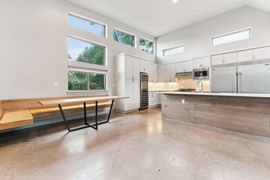 Kitchen with built in appliances, a high ceiling,