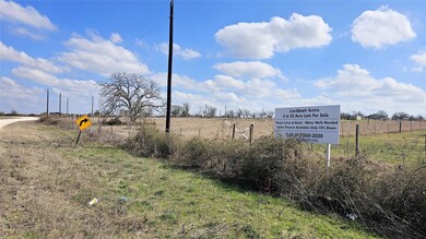 Picture of edge of lot, showing sign to help locate the property during site visit