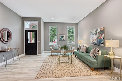 Living room featuring plenty of natural light, light wood finished floors, and recessed lighting