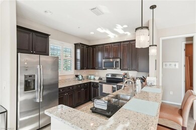Kitchen with dark brown cabinets, stainless steel 