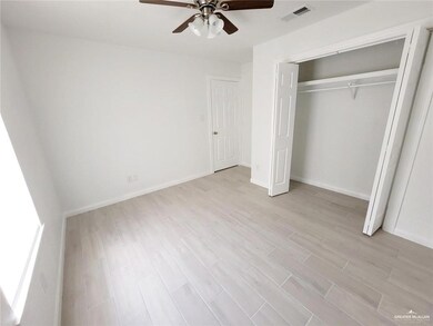 Unfurnished bedroom with light wood-style floors, baseboards, and a closet