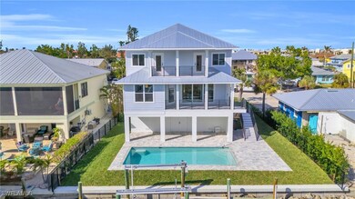 Back of property featuring a fenced in pool, a bal