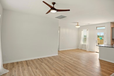 Unfurnished living room featuring light wood fini