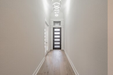 Entryway featuring hardwood / wood-style flooring and baseboards