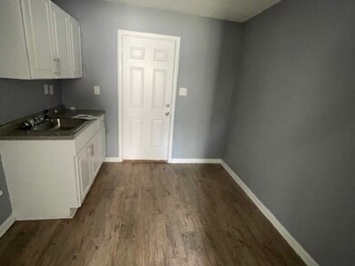 Kitchen with dark hardwood / wood-style flooring, 