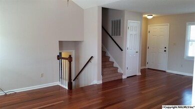 Living Room with fresh paint! Stairs up lead to 3 bedrooms and 2 full bathrooms. Stairs down lead to 3/4 bathroom, laundry, and huge bonus room.