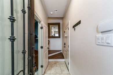 Hardwood and glass entry door with tile flooring.