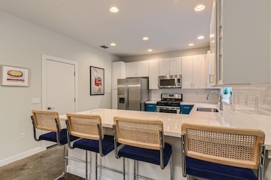 Kitchen with stainless steel appliances, a sink, 