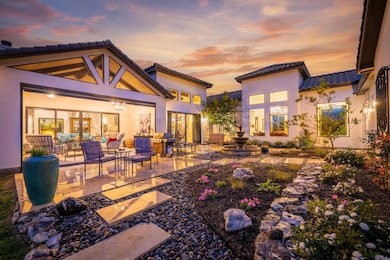 Back of house at dusk featuring outdoor lounge ar