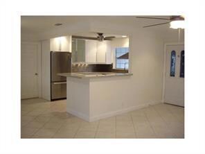 Modern kitchen opens to dining room and living roo