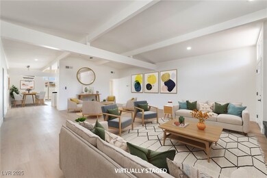 Living area with beam ceiling, light wood finished