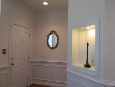 Foyer with coat closet and wood floor