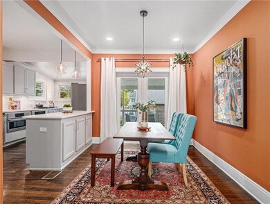 Dining room featuring crown molding and dark hardw