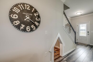 Entryway with baseboards, dark wood finished floors, stairs, and ornamental molding