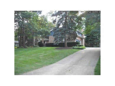 view of drive and side garage