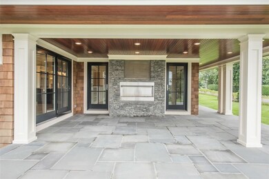 Patio with gas fireplace and TV ready inset above