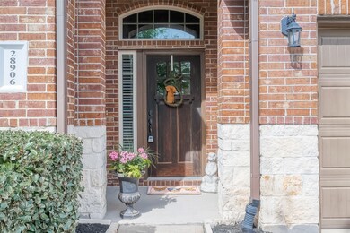 The inviting quaint covered entry beckons with its cozy charm, offering a perfect spot to relax and enjoy the surrounding beauty. Adorned with tasteful decor, it promises moments of tranquility and warm hospitality to visitors and residents alike.