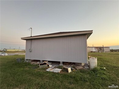 Property exterior at dusk with a yard