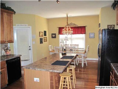 Spacious kitchen features an island with breakfast