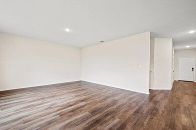 Empty room with wood finished floors, recessed li