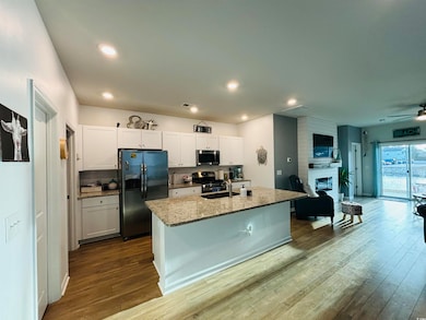 Kitchen with dark wood-style flooring, a sink, app