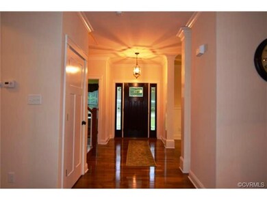 Etched glass entry, hardwood floors and columns ma