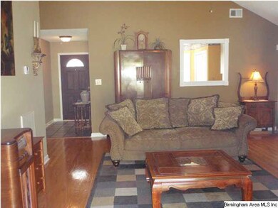 A Great room with gleaming hardwoods, vaulted ceil