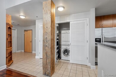 Laundry area with stacked washer and clothes dryer