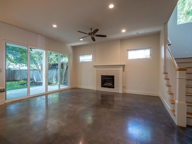 Unfurnished living room featuring finished concre