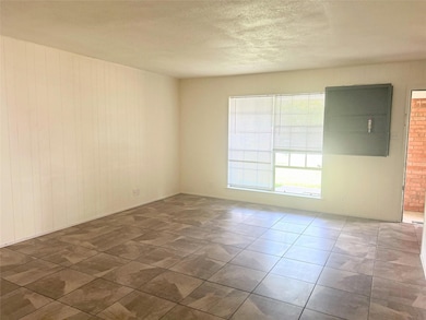 Unfurnished room featuring a textured ceiling and