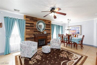 Tiled living area featuring ceiling fan, ornamenta