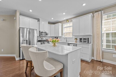 Upgraded 42 inch white cabinets with trim, white subway tile backsplash, and white quartz countertops and island top are the basis of this beautiful kitchen.