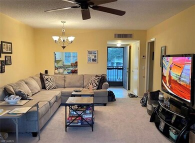Carpeted living room with ceiling fan with notable