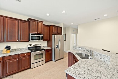 Kitchen with stainless steel appliances, a sink, l