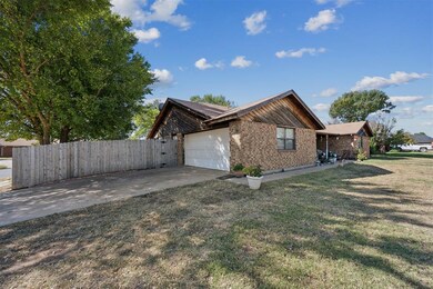 View of front of home with a front yard and a gara