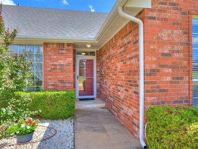 Entrance to property with brick siding and a shingled roof