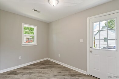 Entryway with wood finished floors and baseboards