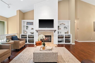 Great room has vaulted ceiling, recessed lighting,