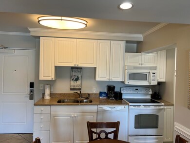 Kitchen with tile patterned flooring, crown moldin
