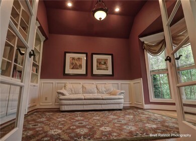 Office with vaulted ceiling, beautiful built-ins, bay window, french doors