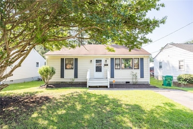 View of front facade with a front yard and crawl space