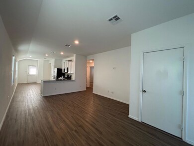 Unfurnished living room with dark wood finished f
