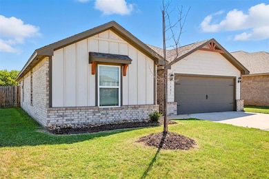 View of front of property with board and batten siding, brick siding, concrete driveway, an attached garage, and a shingled roof
